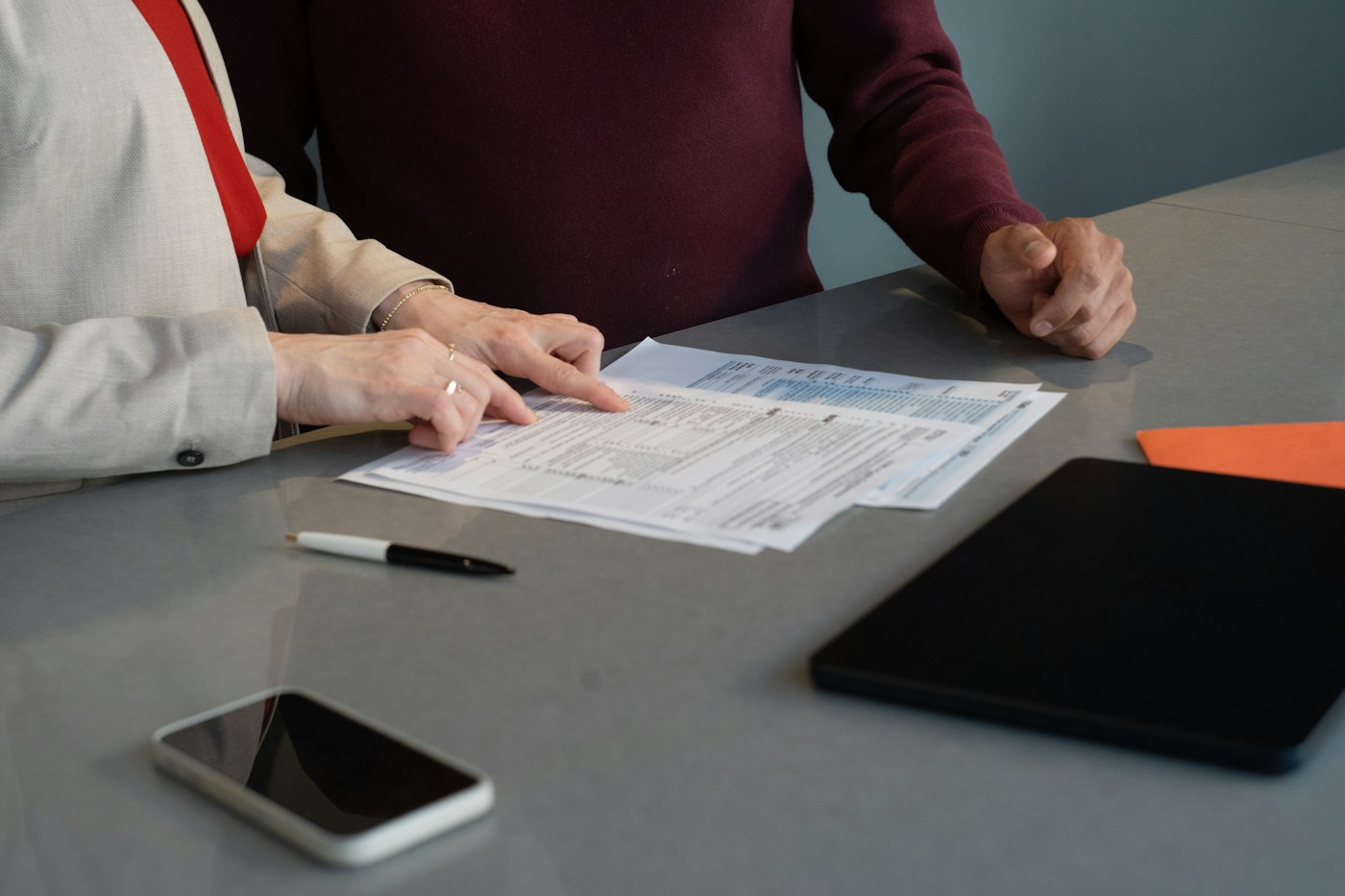 Two professionals reviewing a financial document together at a table