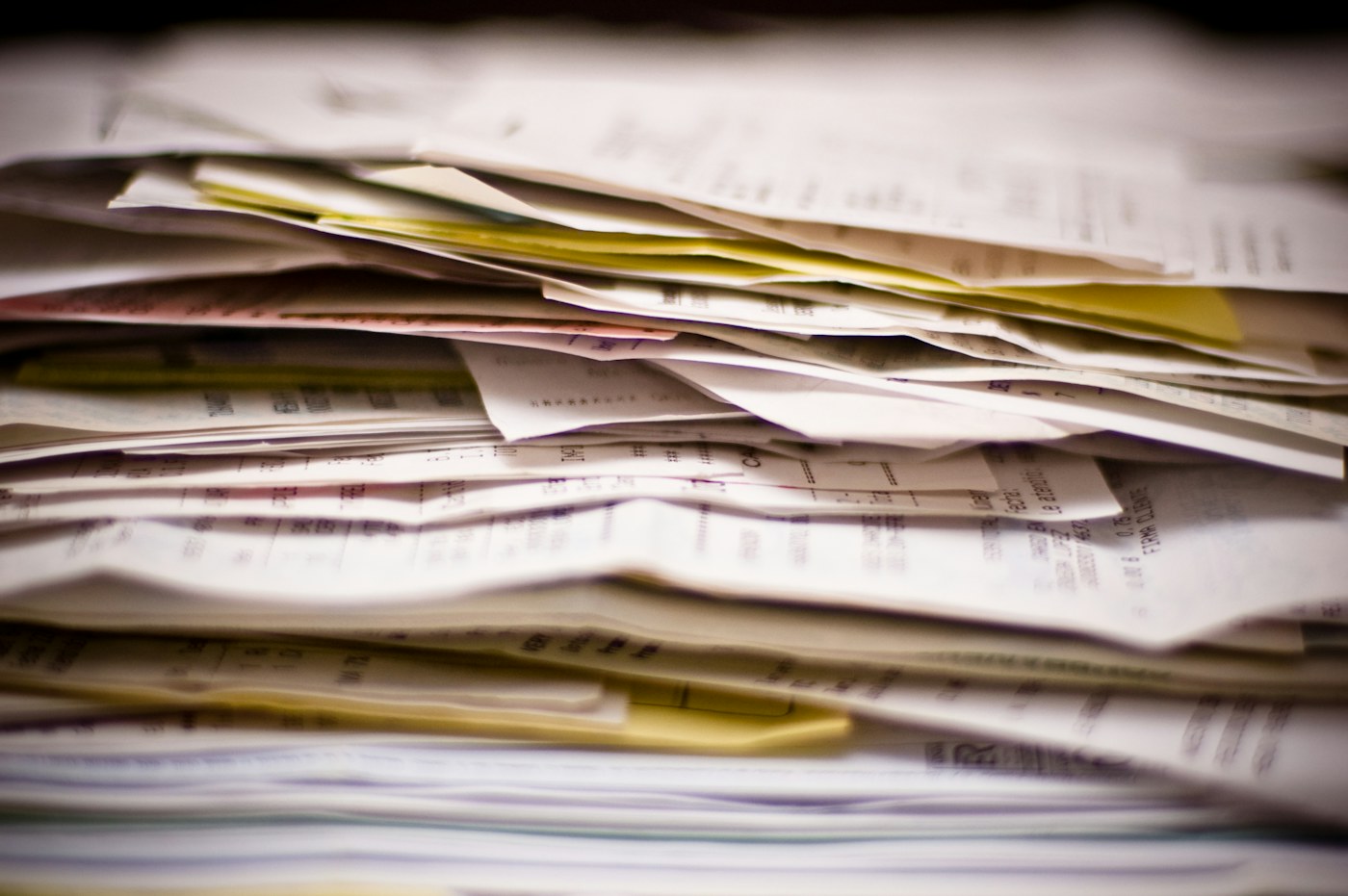 A real stack of invoices and financial paperwork awaiting processing